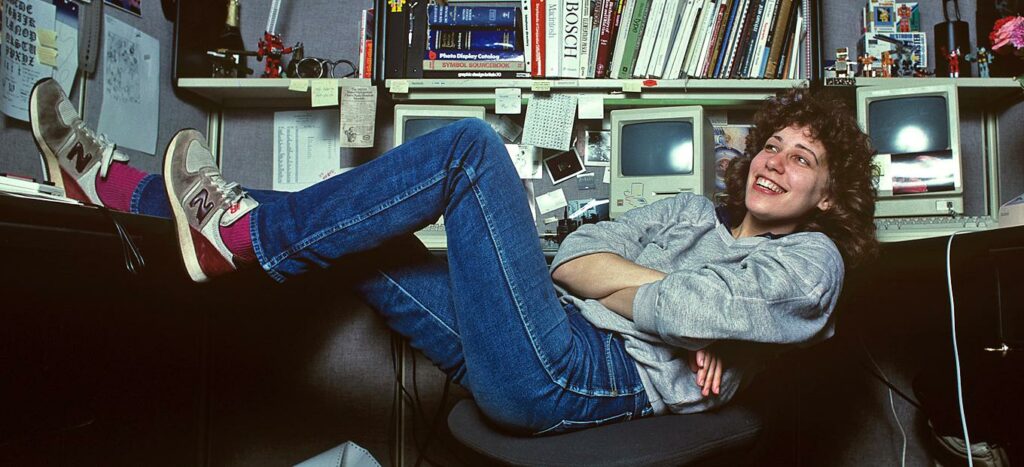 Susan Kare, Apple’s “Macintosh Artist,” relaxes at her desk in 1984. © Norman Seeff